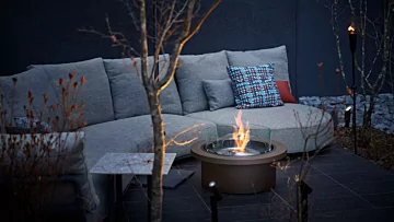 EcoSmart Fire Round 20 Fire Pit Kit adds a sleek black ethanol flame to the FUFU Kyu-Karuizawa garden courtyard.
