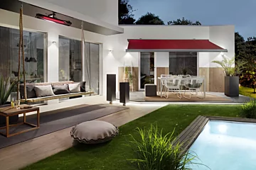 Heatscope Pure 3000W Radiant Heater mounts above the cushioned patio setting in a private residence, supplying efficient outdoor infrared heat.