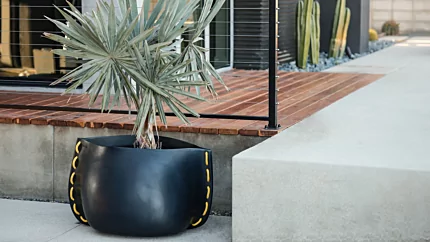 Blinde Design Stitch 75 Planter frames the Starfire garden with sleek graphite concrete for durable modern outdoor appeal.