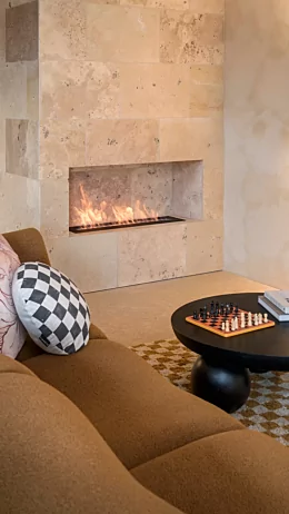 EcoSmart Fire XL900 Ethanol Burner enhances Hipwell Haus by Tim Neve with a sleek built-in ethanol fireplace in the living room.